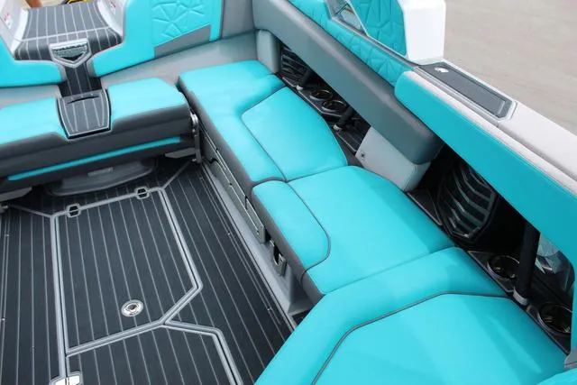 Slide: The Image of 2022 Nautique G23 Paragon interior with turquoise seating and sleek design. - 16