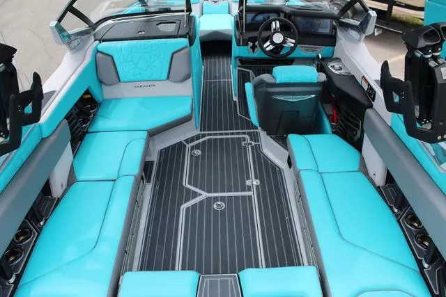 Slide: The Image of 2022 Nautique G23 Paragon interior with turquoise seating and modern dashboard. - 18