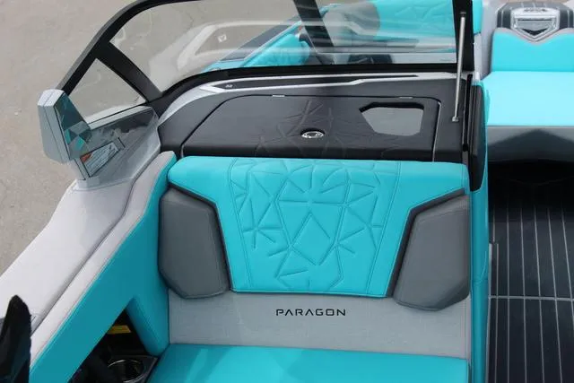 Slide: The Image of 2022 Nautique G23 Paragon interior with turquoise and gray seating. - 22