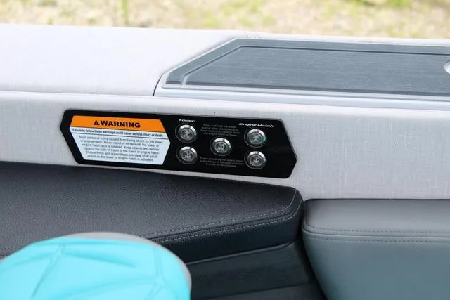 Slide: The Image of Control panel on 2022 Nautique G23 Paragon boat interior with warning label. - 23