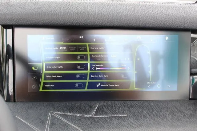Slide: The Image of 2022 Nautique G23 Paragon touchscreen control panel for lighting and heating settings. - 25