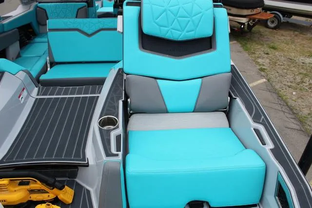 Slide: The Image of 2022 Nautique G23 Paragon boat interior with turquoise and gray seating. - 28