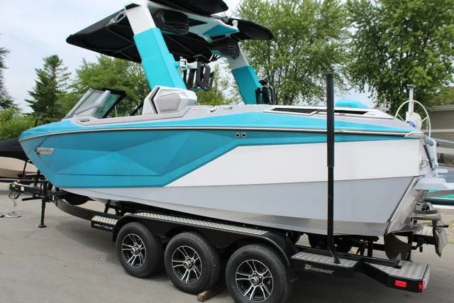 Slide: The Image of 2022 Nautique G23 Paragon boat in vibrant blue on a trailer. - 3