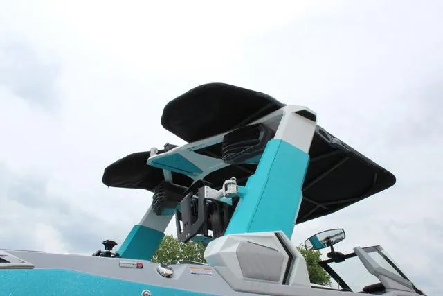 Slide: The Image of 2022 Nautique G23 Paragon boat with advanced tower design against cloudy sky. - 9