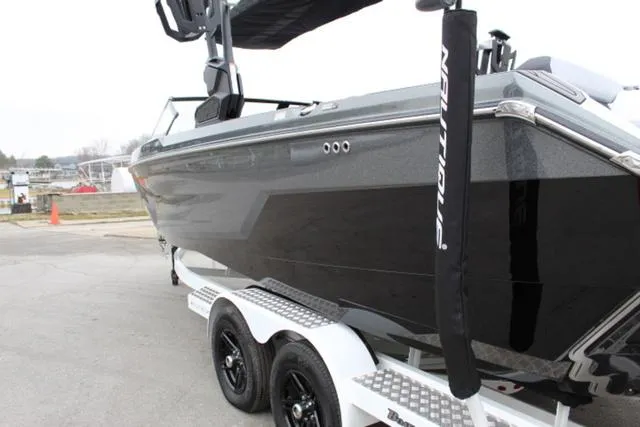 Slide: The Image of 2024 Nautique Super Air Nautique GS22 boat on trailer, sleek black design. - 10