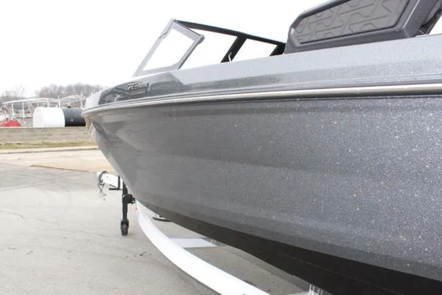 Slide: The Image of 2024 Nautique Super Air Nautique GS22 boat, sleek gray exterior, on trailer. - 11