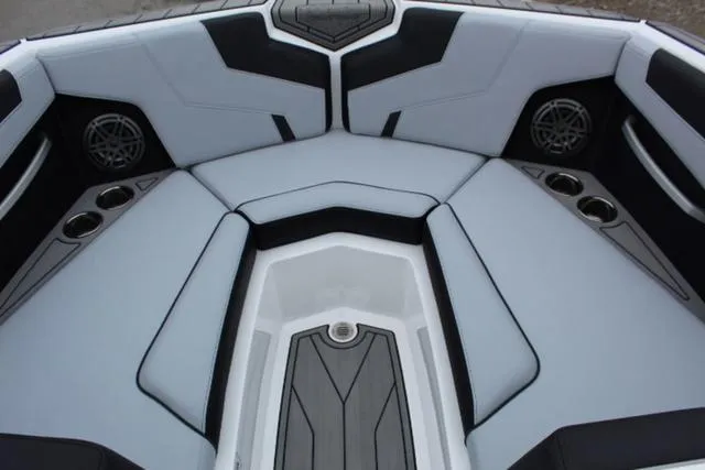 Slide: The Image of 2024 Nautique Super Air Nautique GS22 boat interior with sleek seating and cup holders. - 14