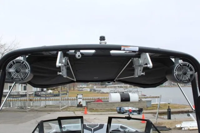 Slide: The Image of 2024 Nautique Super Air Nautique GS22 boat tower with speakers, dockside view. - 19