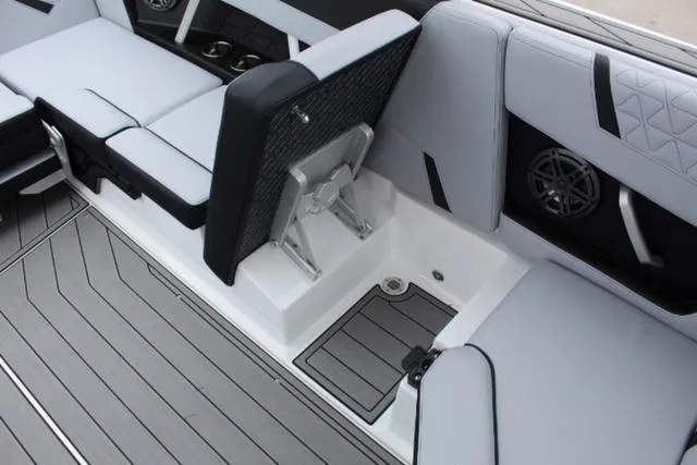 Slide: The Image of Interior of 2024 Nautique Super Air Nautique GS22 boat with sleek seating and storage. - 23