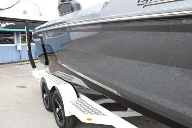 Slide: The Image of 2024 Nautique Super Air Nautique GS22 on a trailer, sleek black exterior. - 5