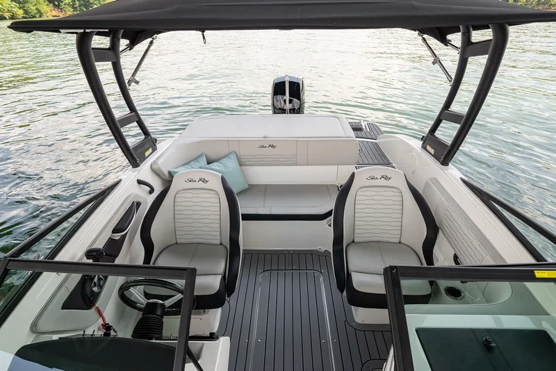 Slide: The Image of 2023 Sea Ray SPX 190 boat interior with seating, steering wheel, and water view. - 10