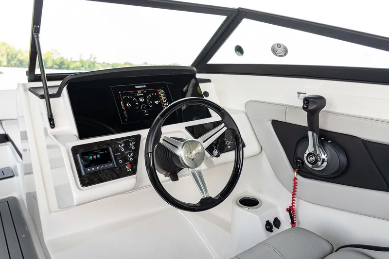 Slide: The Image of 2023 Sea Ray SPX 190 boat dashboard with steering wheel and control panel. - 12