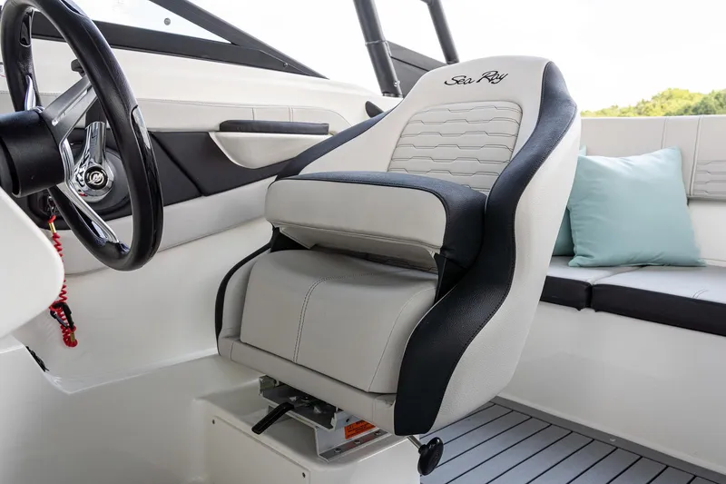 Slide: The Image of 2023 Sea Ray SPX 190 boat interior with steering wheel and cushioned seating. - 16