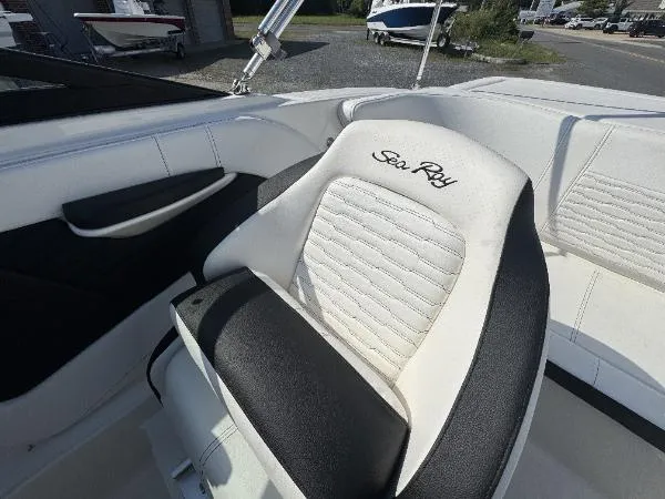 Slide: The Image of 2023 Sea Ray SPX 190 boat seat with embroidered logo, featuring sleek white and black design. - 2
