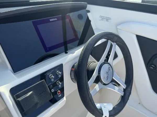 Slide: The Image of 2023 Sea Ray SPX 190 dashboard with steering wheel and control panel. - 3