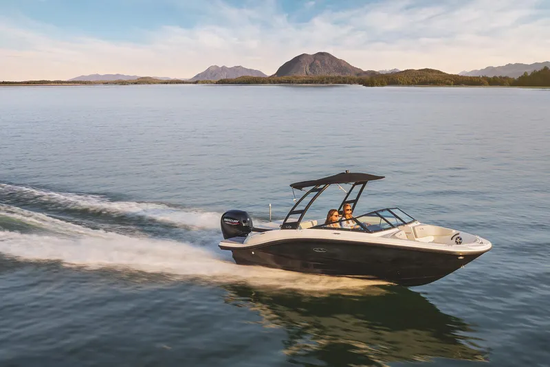 Slide: The Image of 2023 Sea Ray SPX 190 boat cruising on a serene lake with mountainous backdrop. - 7