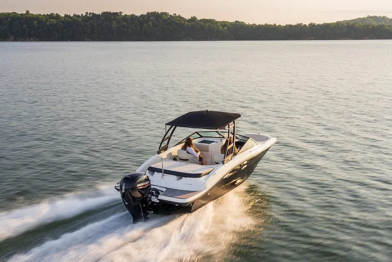 Slide: The Image of 2023 Sea Ray SPX 190 boat cruising on a serene lake at sunset. - 8