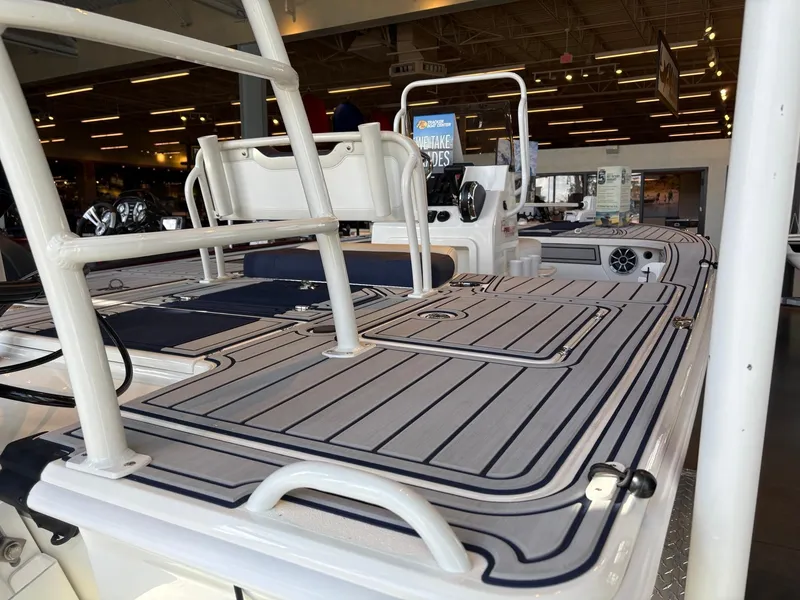 Slide: The Image of 2025 Mako 18 Pro Skiff Patriot Edition boat interior with sleek deck design. - 14