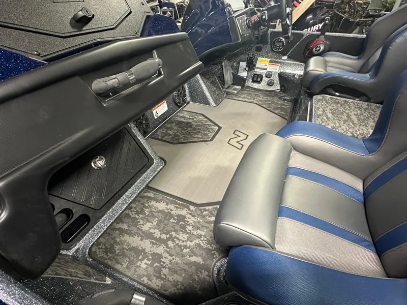 Slide: The Image of 2025 Nitro Z21 XL Pro boat interior with blue and gray seating and modern dashboard. - 12