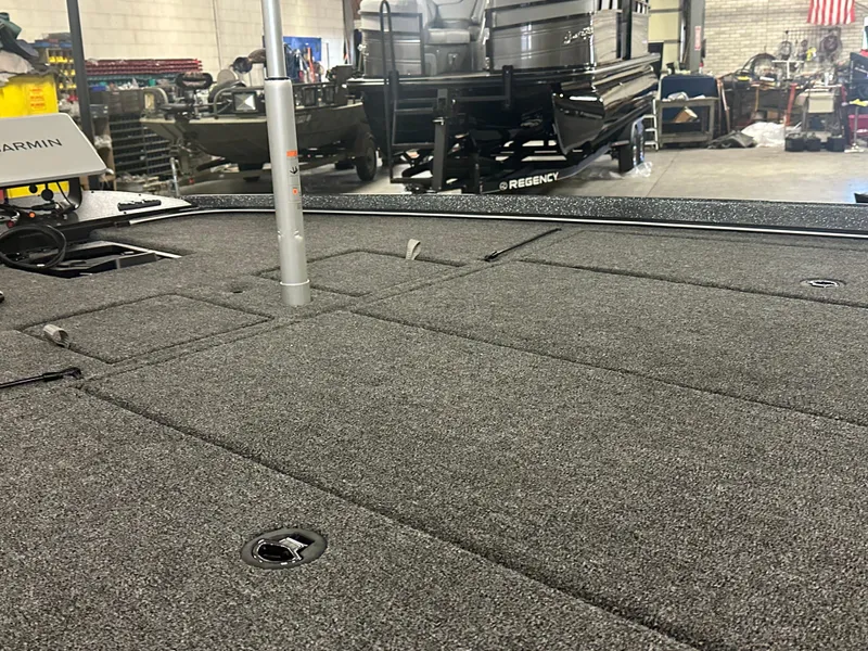 Slide: The Image of 2025 Nitro Z21 XL Pro boat deck with storage compartments in a workshop setting. - 17