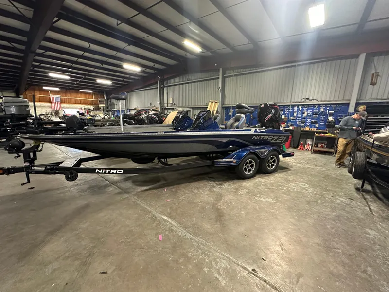 Slide: The Image of 2025 Nitro Z21 XL Pro boat in a spacious indoor garage setting. - 2