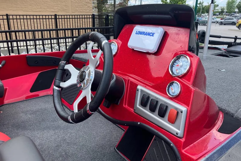 Slide: The Image of Red 2025 Nitro Z19 boat dashboard with steering wheel and Lowrance electronics. - 3