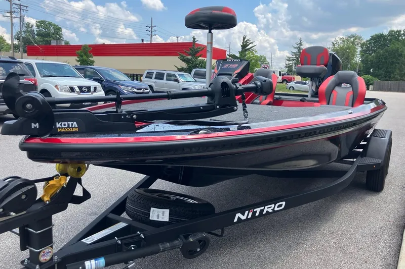 Slide: The Image of 2025 Nitro Z19 boat with Minn Kota Maxxum motor, parked outdoors. - 5