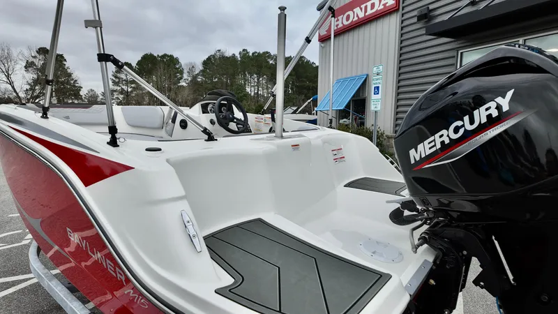 Slide: The Image of 2025 Bayliner M15 boat with Mercury engine, parked outdoors near a Honda dealership. - 11