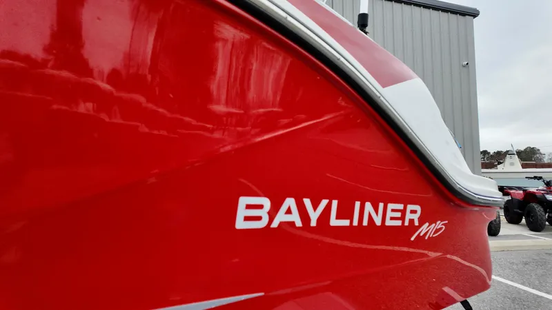 Slide: The Image of 2025 Bayliner M15 boat, red exterior, close-up view. - 2