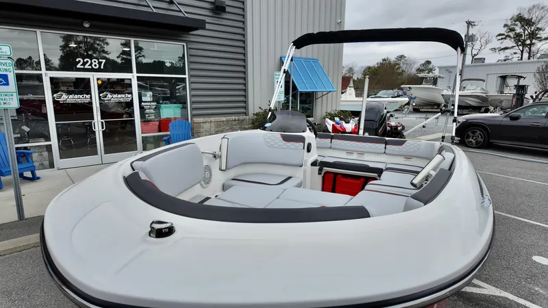 Slide: The Image of 2025 Bayliner M15 boat with spacious seating, displayed outside a dealership. - 4