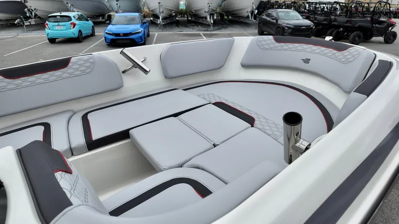 Slide: The Image of 2025 Bayliner M15 boat interior with sleek gray seating in a parking lot. - 9