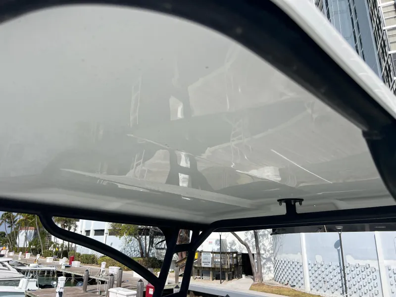 Slide: The Image of 2014 Everglades 350LX boat canopy with marina background. - 42