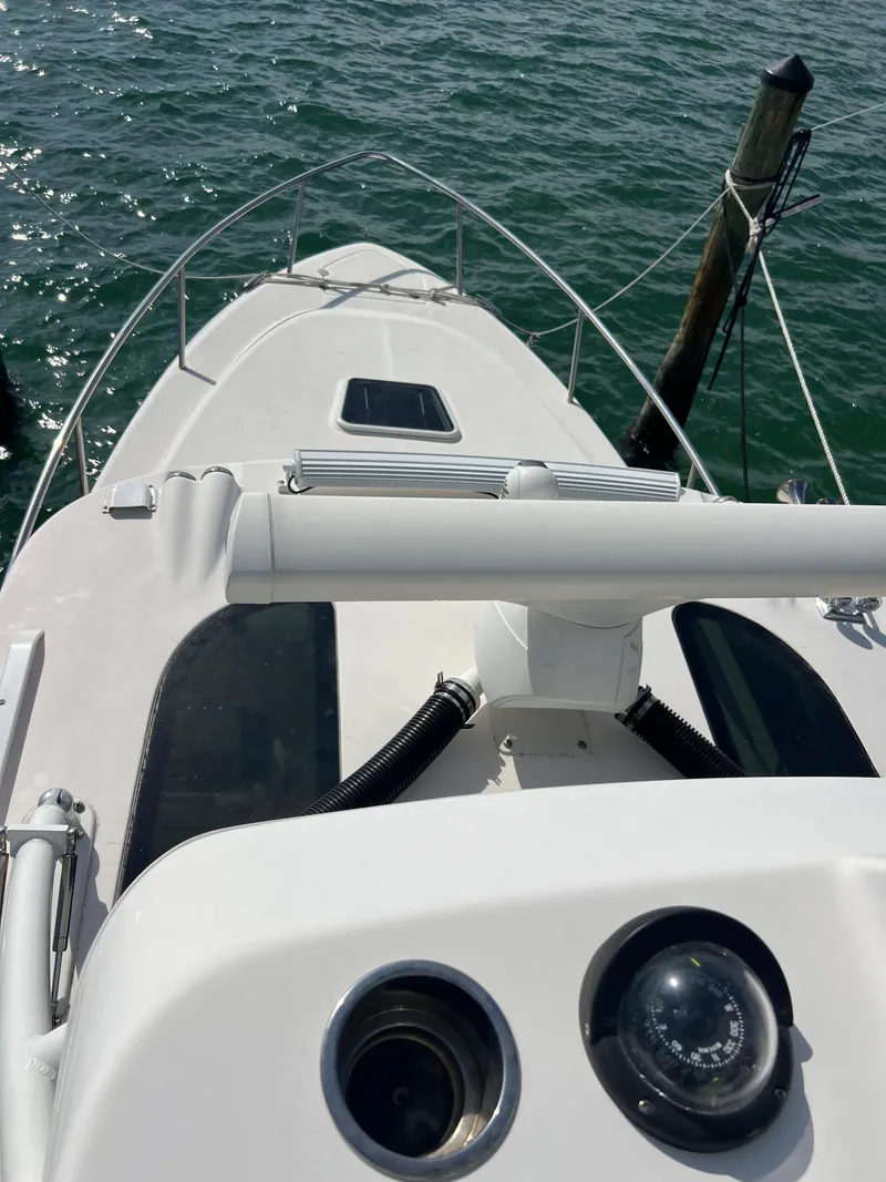 Slide: The Image of 2014 Everglades 350LX boat docked on calm water. - 43