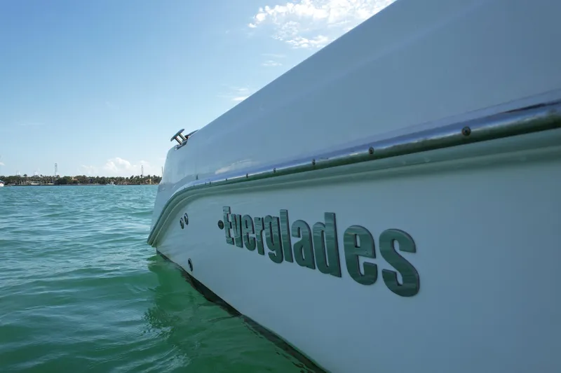 Slide: The Image of 2014 Everglades 350LX boat on calm water under clear sky. - 62