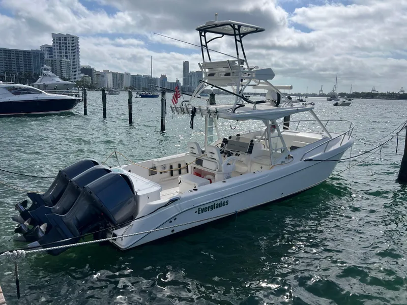 Slide: The Image of 2014 Everglades 350LX boat docked in a marina with city skyline. - 7