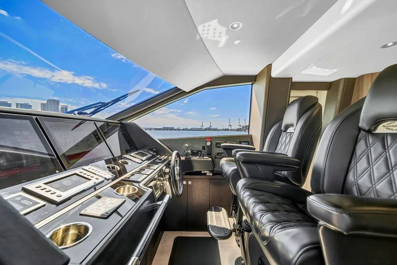 Slide: The Image of Luxurious Sunseeker 86 Yacht 2021 helm with leather seats and modern controls. - 27