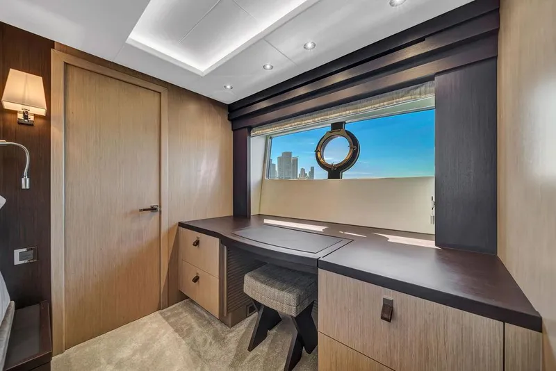 Slide: The Image of Luxurious Sunseeker 86 Yacht 2021 interior with elegant desk and scenic window view. - 36