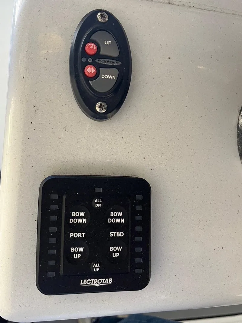 Slide: The Image of Control panel of a 2020 Yellowfin 26 boat with Lectrotab trim tab switches. - 12