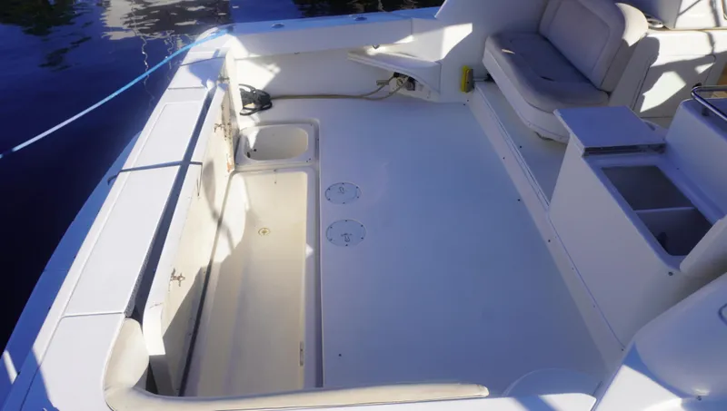 Slide: The Image of 2002 Sea Ray 340 Amberjack boat deck with seating and storage compartments. - 11