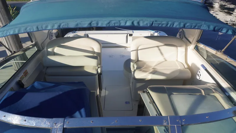 Slide: The Image of 2002 Sea Ray 340 Amberjack boat interior with blue canopy and white seating. - 14