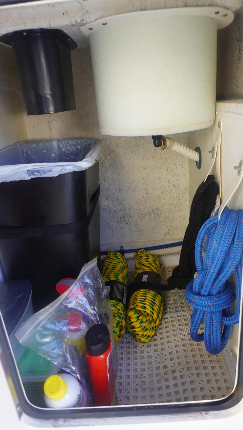 Slide: The Image of Storage compartment on a 2002 Sea Ray 340 Amberjack with ropes and cleaning supplies. - 16