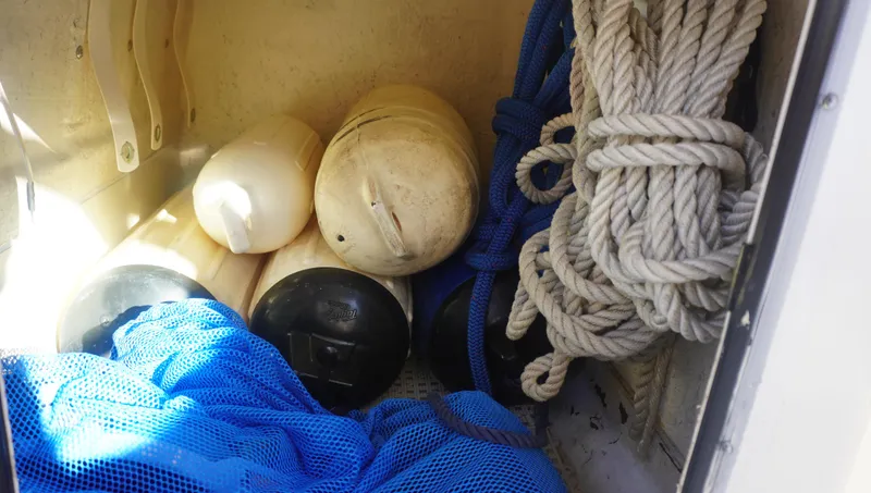 Slide: The Image of Boat storage with ropes, buoys, and netting on a 2002 Sea Ray 340 Amberjack. - 18
