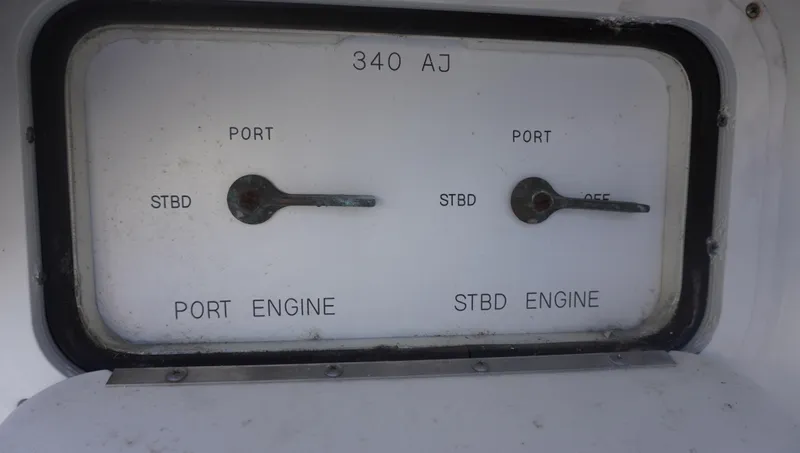 Slide: The Image of Control panel of 2002 Sea Ray 340 Amberjack boat, showing port and starboard engine switches. - 19