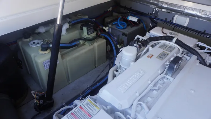 Slide: The Image of Engine compartment of 2002 Sea Ray 340 Amberjack, showcasing mechanical components and wiring. - 23