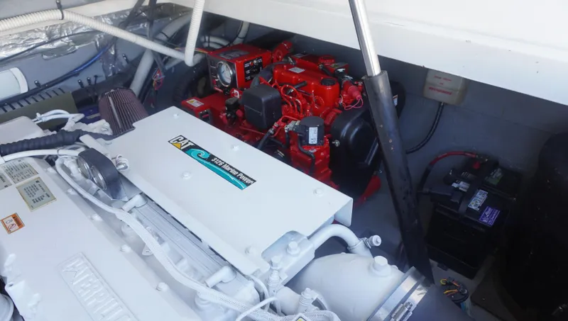 Slide: The Image of Engine compartment of a 2002 Sea Ray 340 Amberjack boat, featuring a red engine. - 24