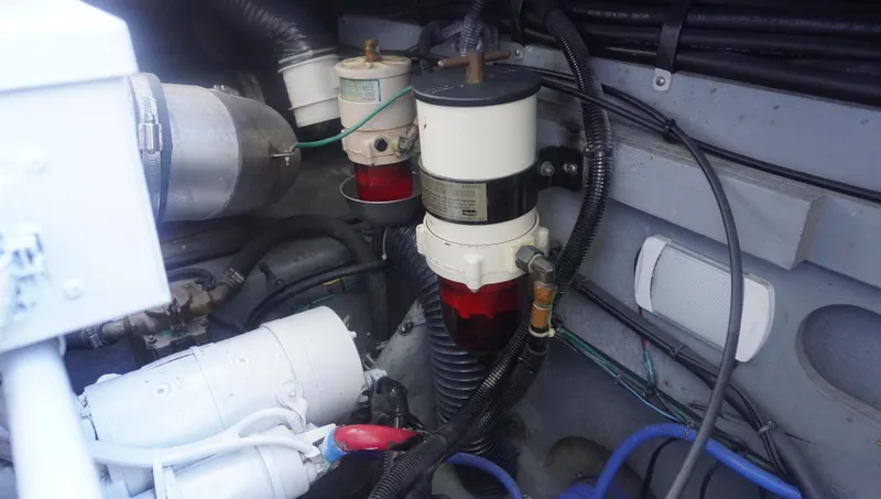 Slide: The Image of Engine compartment of 2002 Sea Ray 340 Amberjack, showing fuel filters and wiring. - 25