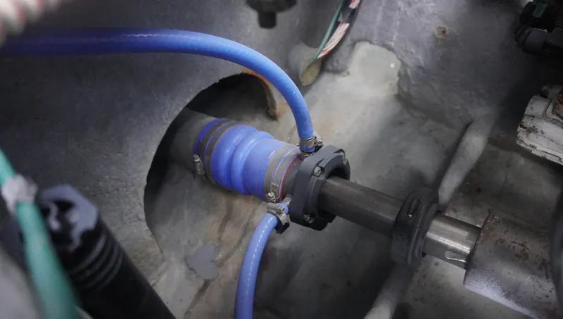 Slide: The Image of Engine compartment of 2002 Sea Ray 340 Amberjack with blue hose and shaft. - 28