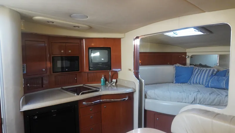 Slide: The Image of Interior of 2002 Sea Ray 340 Amberjack with kitchenette and cozy sleeping area. - 31