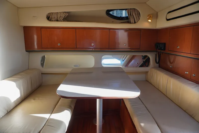 Slide: The Image of Interior of 2002 Sea Ray 340 Amberjack with wooden cabinets and beige seating. - 35