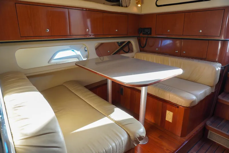 Slide: The Image of Interior of 2002 Sea Ray 340 Amberjack with cozy seating and wooden cabinetry. - 36
